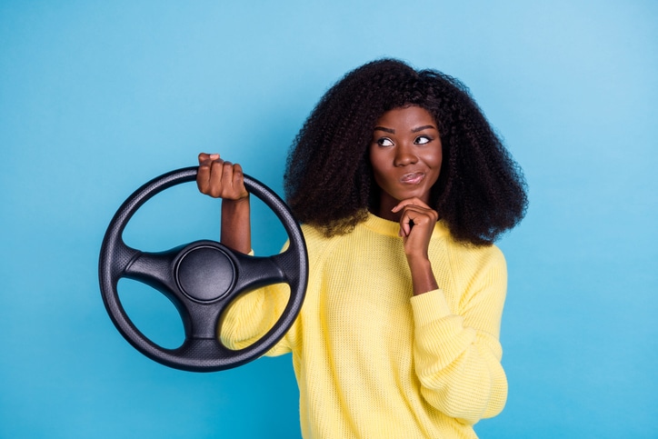 black woman ponders car